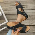 Detailed view of black women's wedge sandals with hollow patterns and white stitching. - 36 / Black