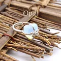 Elegant heart-shaped opal ring with silver bow accent in a natural rustic style - Opal