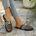 Detail of leopard print breathable fishnet mules with gold buckle on stone floor - 36 / Black