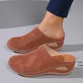 Detail view of stylish brown closed-toe wedge mules highlighting the 6cm heel height. - 36 / Brown