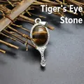 Elegant ornate silver-tone hand mirror pendant featuring an oval tiger's eye gemstone - Tiger's Eye