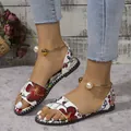 Detail view of women's floral flat sandals with pearl and gold metal ankle straps - 35 / Beige