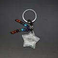Natural white crystal star keychain featuring colorful bead tassel on dark background - White Crystal