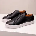 Detailed close-up of premium black leather men's sneakers featuring a white thick sole design - 38 / Black
