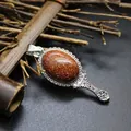 Vintage style goldstone mirror-shaped pendant with silver-tone intricate carvings - Gold Sandstone