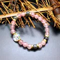 Detail of a handmade strawberry quartz bracelet with a faceted aurora crystal bead. - Pink Strawberry Crystal Style / 8mm Bead