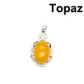 Elegante colgante plateado calado con un suave topacio amarillo ovalado en el centro - Topacio