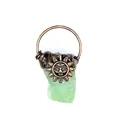 Detailed macro view of a raw green crystal pendant with an antique bronze sun face carving - Green Fluorite Sunflower (Bronze)