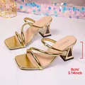 Detail showing the 8cm triangular block heel on metallic gold square toe sandals - 36 / Gold