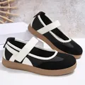 Modern black and white Mary Jane flat shoes featuring a Velcro strap and textured sole. - 36 / Black