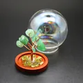 Macro view of green crystal leaves and copper wire trunk on the miniature tree of life ornament - Aventurine Jade