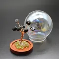 Close-up of mini natural stone life tree ornament with glass dome for home decor. - Obsidian