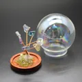 Close-up of a miniature crystal tree of life with a decorative glass dome on wooden base - Rainbow Fluorite