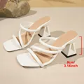 Detailed close-up showing the 8cm triangular block heel of white strappy sandals - 36 / White