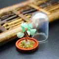 Detailed view of mini crystal tree of life with clear glass dust dome and wood base - Aventurine Jade