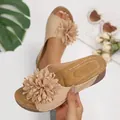 Close-up of beige wedge platform slippers with oversized textile flower decoration - Off White