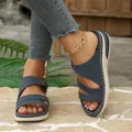 Detail view of navy blue wedge sandals for women with thick soles and buckle details. - 36 / Blue