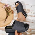 Close-up of women's denim platform slides with 'FASHION' insole and woven sole edge. - 36 / Dark Blue