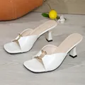 Detail of white crocodile patterned square toe mules with gold metal ring decoration. - 35 / White