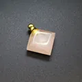 Close-up of a diamond-shaped rose quartz stone perfume bottle pendant with golden screw cap - Rose Quartz / Gold
