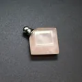 Macro detail of a rhombic rose quartz perfume bottle pendant with a silver screw cap - Rose Quartz / Silver