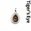 Vintage silver teardrop lace pendant featuring a polished natural tiger's eye gemstone - Tiger's Eye