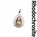 Natural rhodonite teardrop pendant with an intricate silver-tone filigree frame design - Rhodonite