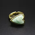 Close-up of vintage heart ring with green natural stone on elegant black background - Amazonite