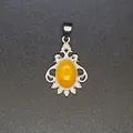 Elegant vintage-style silver pendant featuring a vibrant yellow oval topaz stone - Topaz