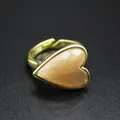 Detailed view of vintage heart-shaped ring with a champagne-colored natural stone - Sunstone