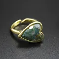 Detailed macro view of vintage heart-shaped ring featuring a green natural moss agate stone - Moss Agate