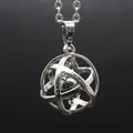 Detailed macro shot of an intricate silver hollow sphere pendant with hematite stone - Hematite
