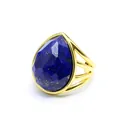 Macro view of a faceted blue lapis lazuli pear ring with a gold triple hollow band detail - Lapis Lazuli