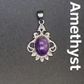 Elegant vintage silver-toned filigree pendant featuring a polished oval purple amethyst stone - Amethyst