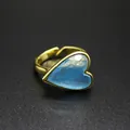 Detailed close-up of a vintage gold ring featuring a faceted blue heart-shaped natural stone - Blue Chalcedony