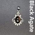Vintage silver-tone black onyx pendant with filigree details and crystal accents. - Black Agate
