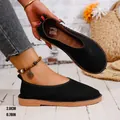 Detail view showing the 2.0cm flat heel height of these black suede vintage flats. - 36 / Black