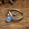 Close-up of silver-tone open ring featuring a fox silhouette and blue crystal bead. - Aquamarine