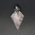 Detailed macro view of a natural rose quartz kite-shaped pendant with a trident metal cap - Rose Quartz (Poseidon Trident)