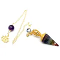 Close-up of 7 chakra resin crystal dowsing pendulum with golden lotus charm and chain. - Rainbow