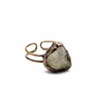 Macro view of a vintage copper ring featuring a raw natural quartz crystal stone - Super Seven Quartz