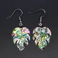Detailed view of iridescent abalone shell monstera leaf drop earrings on dark background - Iridescent Abalone Shell (1)
