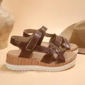 Detailed view of women's brown wedge sandals with crisscross straps and velcro - 36 / Brown