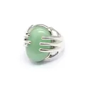 Close-up detail of a silver palm-shaped ring clutching a green oval natural stone - Aventurine Jade