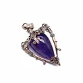 Macro view of the intricate bronze metalwork on a purple crystal stone pendant - Amethyst
