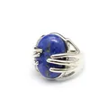Silver adjustable ring with a unique hand-shaped clasp holding an oval blue lapis lazuli stone. - Lapis Lazuli