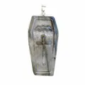 Close-up detail of a hand-carved cross on a natural labradorite coffin-shaped pendant - 55x26x9mm