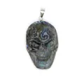 Close-up of hand-carved natural labradorite skull pendant showing blue labradorescence - 42x25x10mm