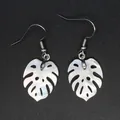 Detailed view of white shell Monstera leaf earrings with shimmering pearly texture. - Simple Natural White Shell (3)
