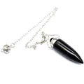 Detail of a black natural stone bullet-shaped dowsing pendulum with silver chain. - Obsidian